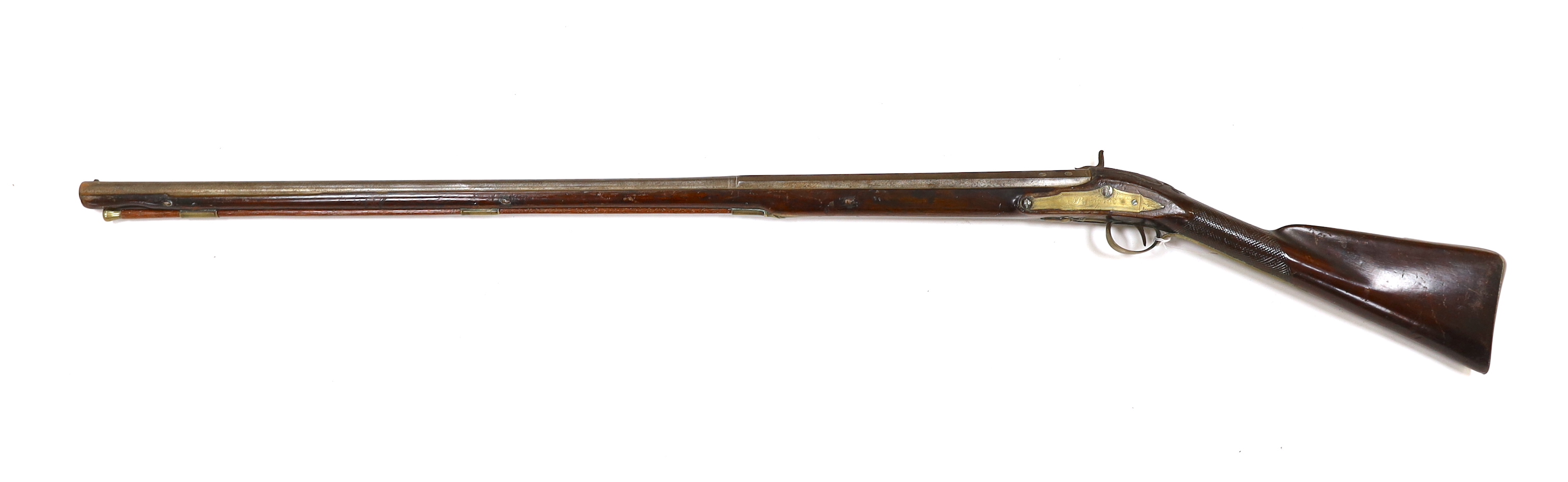 A 1786 percussion 12 bore fowling piece, converted from flintlock, with a fully stocked half octagonal barrel, London proofs, brass furniture and sideplate engraved IR 1786, chequered grip and wooden ramrod, barrel 96cm